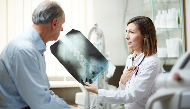 Doctor and patient reviewing the patient&#039;s x-ray.